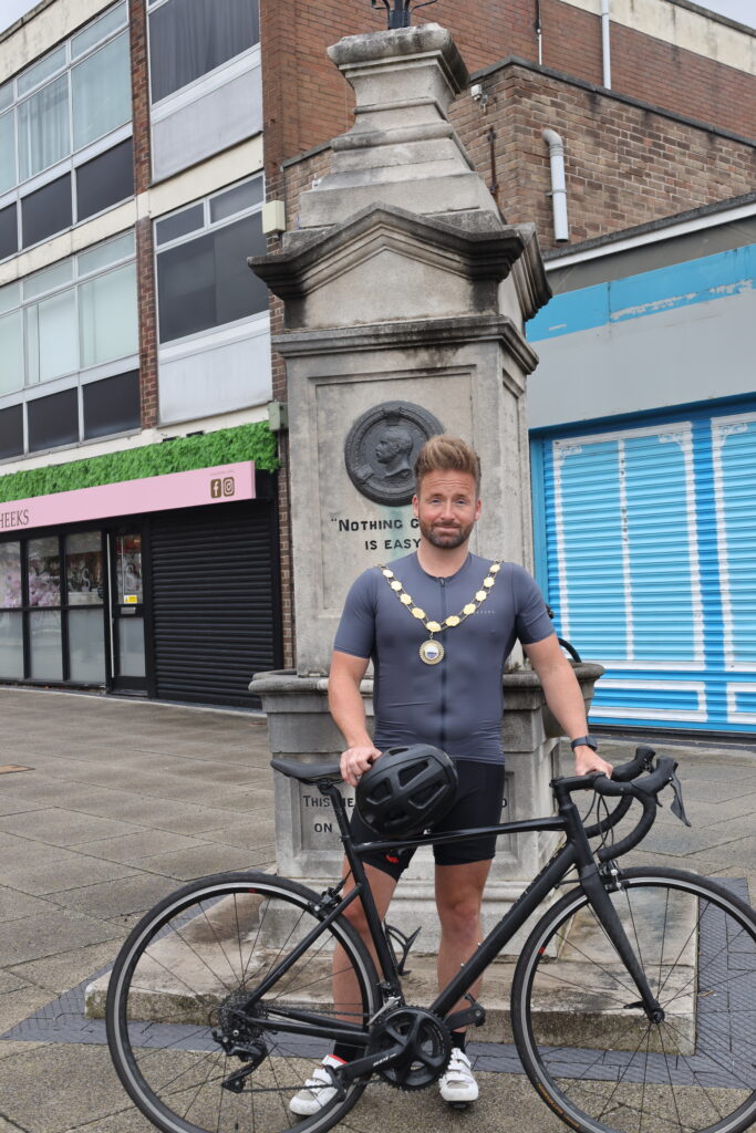Cllr Ian Preece standing by the Captain Webb Monument in Dawley