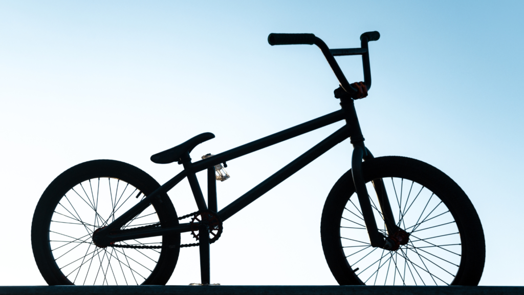 silhouette of a BMX bike with a blue sky in the background