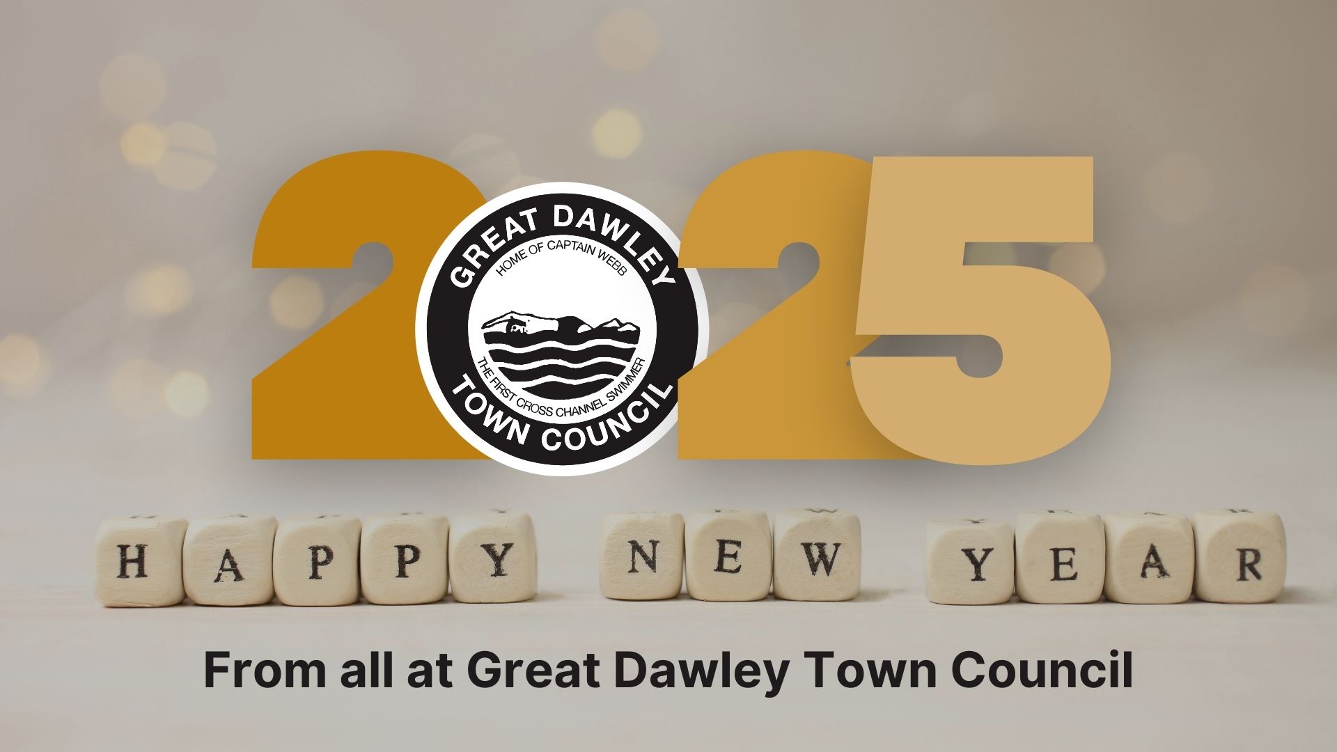 2025 Happy New Year graphic from Great Dawley Town Council. The image features the text '2025' in bold gold letters with the Great Dawley Town Council logo in the center, and wooden blocks spelling 'HAPPY NEW YEAR' at the bottom. The background is soft and blurred with bokeh lights.