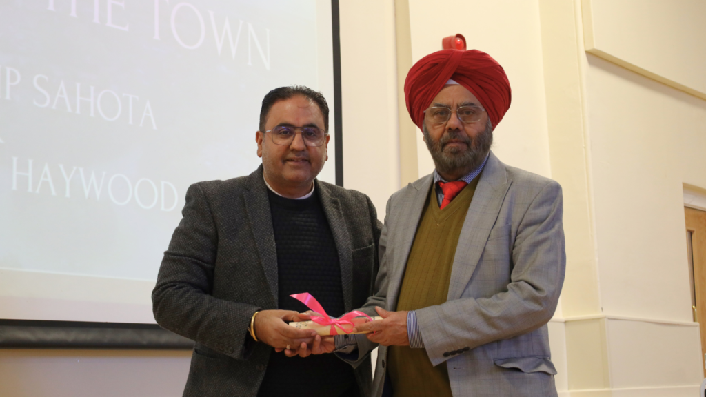 Lord Kuldip Sahota receiving his Freedom of the Town scroll from Cllr Raj Mehta.