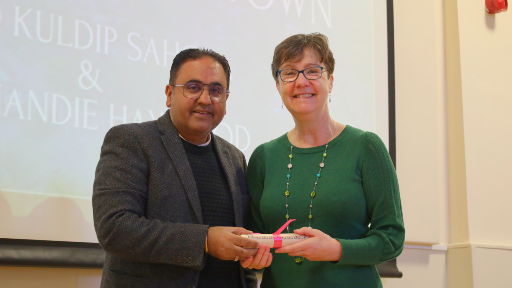 Mandie Haywood receiving her Freedom of the Town scroll from Cllr Raj Mehta.