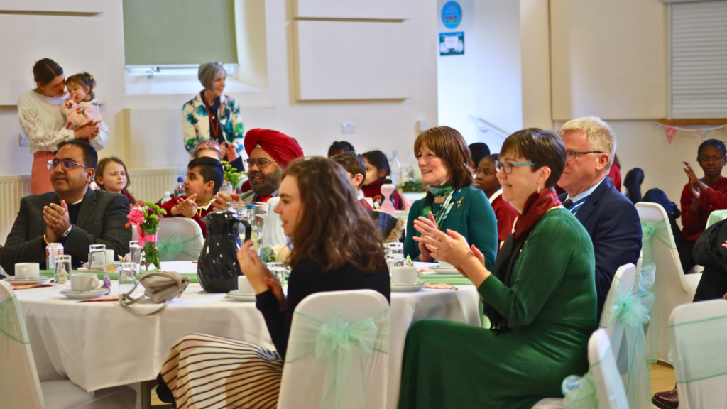 Dignitaries and guests enjoying the performance by Old Park Primary School.